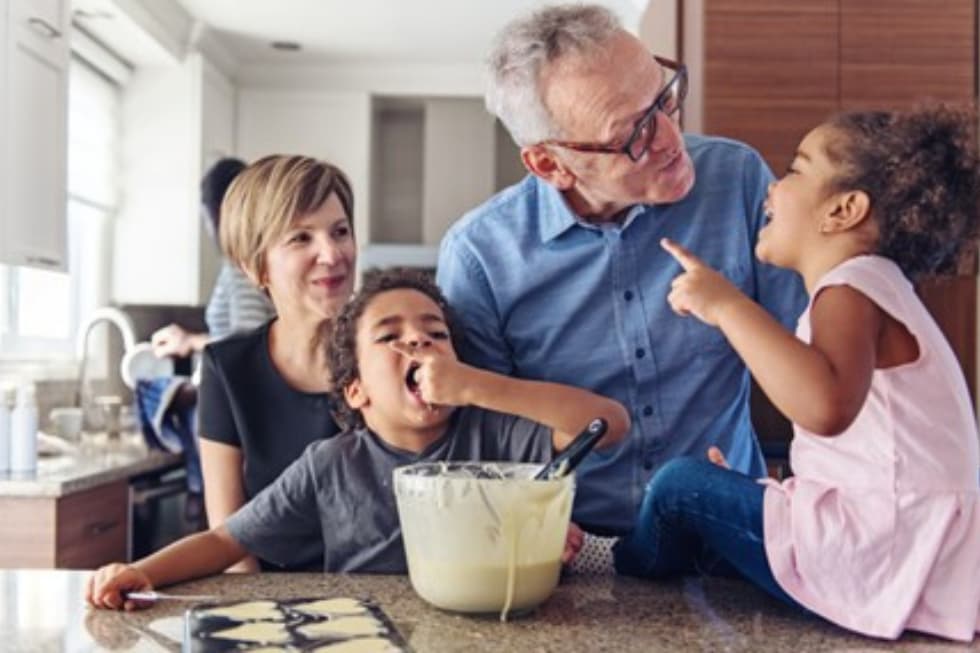 Grandparents modelling taking turns whilst making cookies.